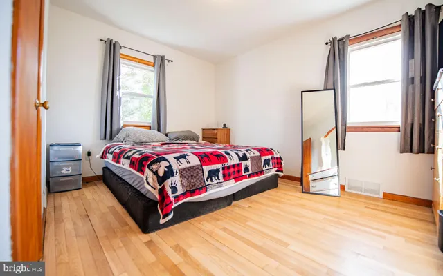 a bedroom with a bed lamp and a window