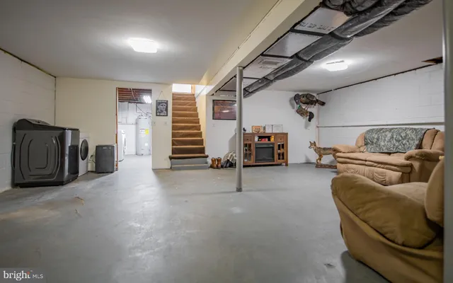 a living room with furniture and a walk in closet