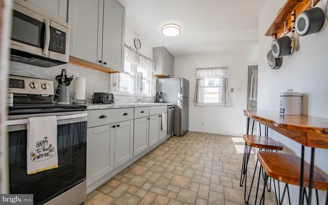 a kitchen with stainless steel appliances granite countertop a sink and cabinets