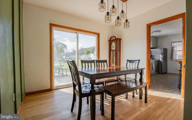 a dining room with furniture window and wooden floor
