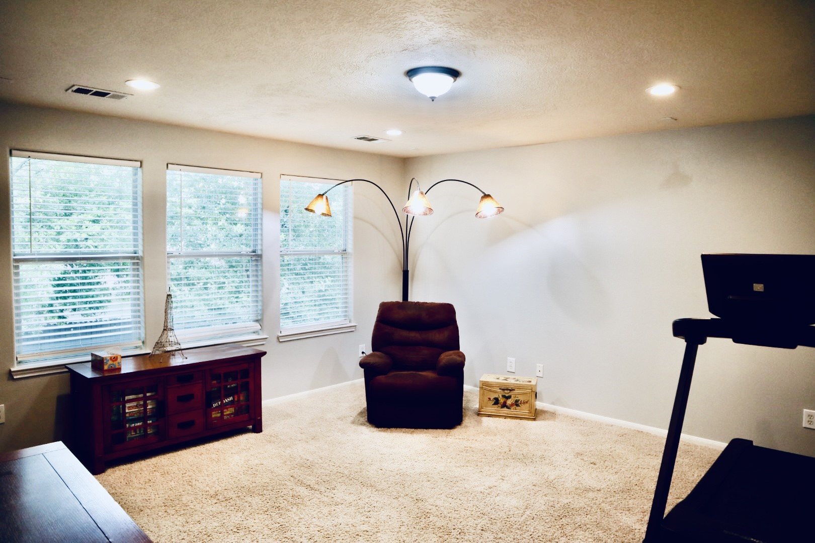 19114 Emory Trail Spring, TX 77388 - Photo 20 of 32 The Game Room features soft carpet flooring, a large window with blinds providing ample natural light, and a central ceiling light. It is versatile for relaxation, entertainment or exercise.