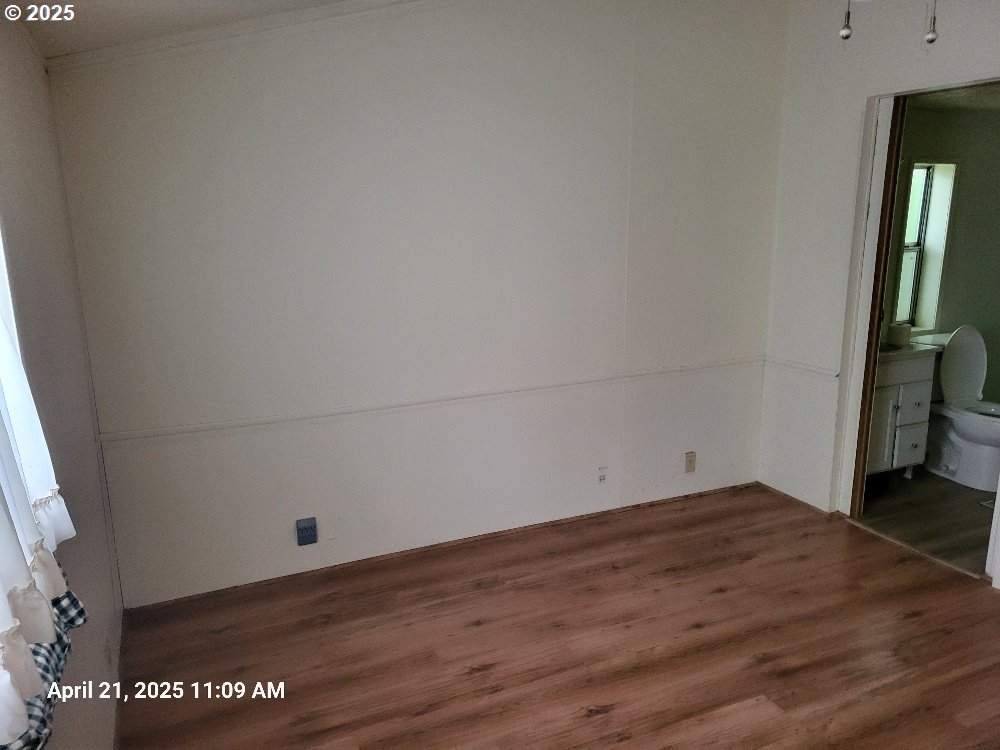 1050 North Cedar Point Road Coquille, OR 97423 - Photo 14 of 29 a view of empty room with wooden floor