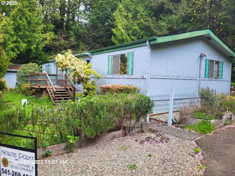 1050 North Cedar Point Road Coquille, OR 97423 - Photo 2 of 29 a backyard of a house with lots of green space