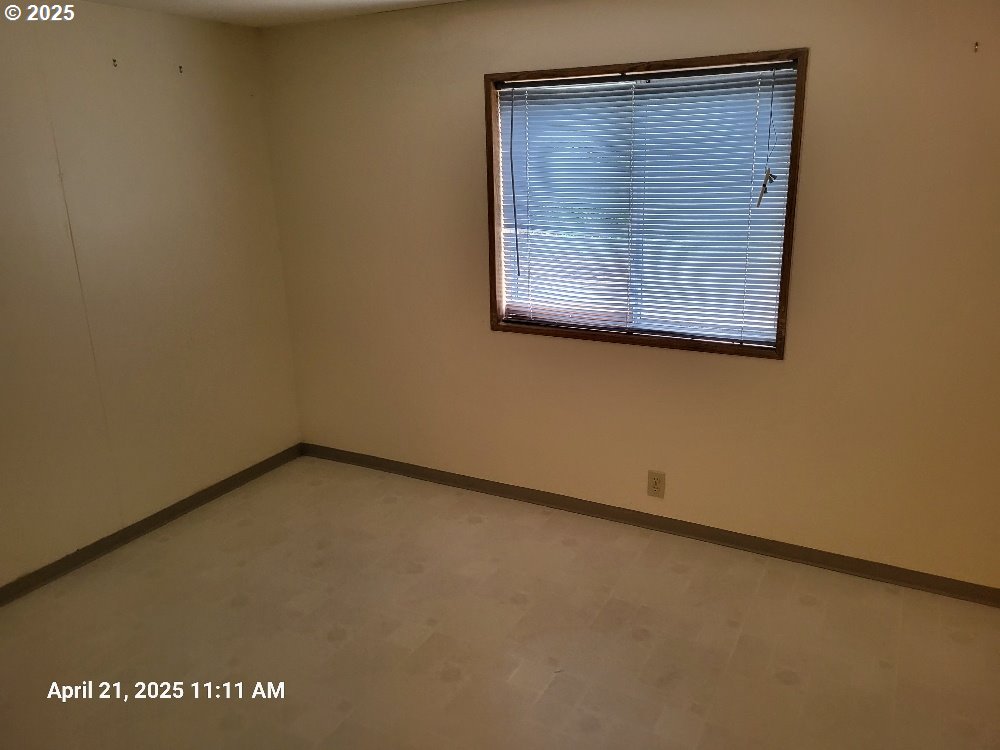 1050 North Cedar Point Road Coquille, OR 97423 - Photo 21 of 29 an empty room with a window