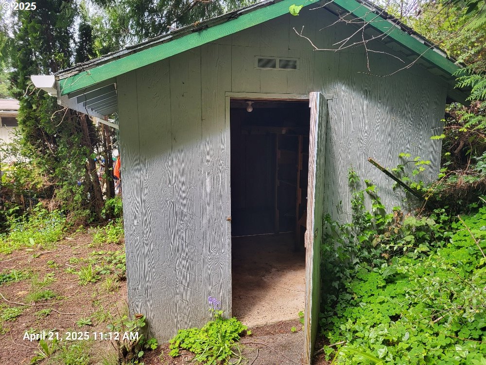 1050 North Cedar Point Road Coquille, OR 97423 - Photo 26 of 29 a couple of flower plants in front of door