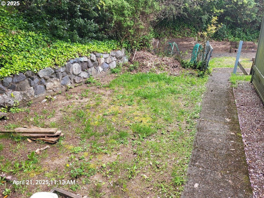 1050 North Cedar Point Road Coquille, OR 97423 - Photo 29 of 29 a view of a garden with plants and a bench