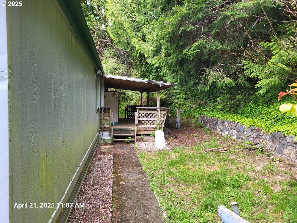 1050 North Cedar Point Road Coquille, OR 97423 - Photo 3 of 29 a backyard of a house with table and chairs