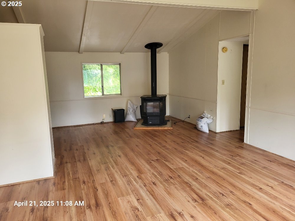 1050 North Cedar Point Road Coquille, OR 97423 - Photo 5 of 29 a view of empty room with wooden floor and fan