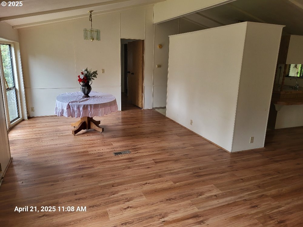 1050 North Cedar Point Road Coquille, OR 97423 - Photo 6 of 29 a view of a room with wooden floor and chair