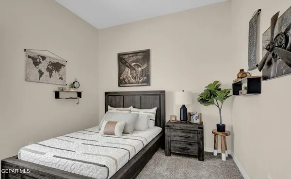 a bedroom with a bed and a potted plant