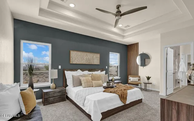 a bedroom with furniture and a large window