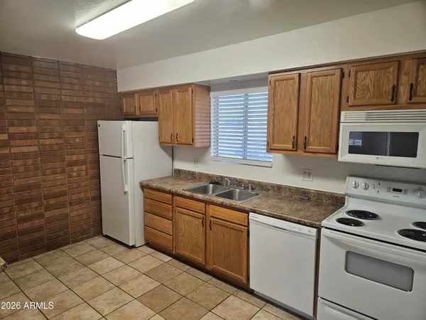 a kitchen with granite countertop cabinets stainless steel appliances and a counter space
