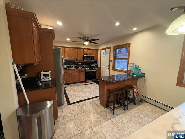 a living room with furniture a dining table and kitchen view
