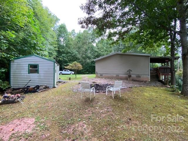759 Winchester Road Bryson City, NC 28713 - Photo 3 of 17 a backyard of a house with yard and trampoline