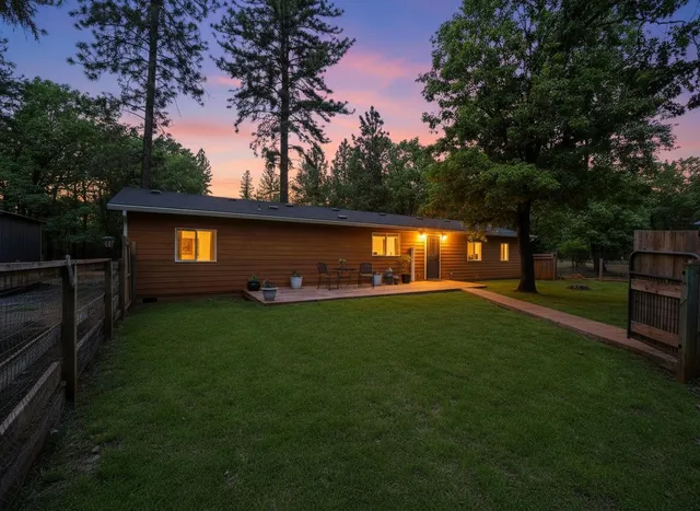a backyard of a house with lots of green space and outdoor seating