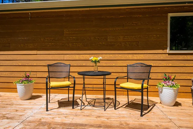 a bed room with a bed a television and dresser