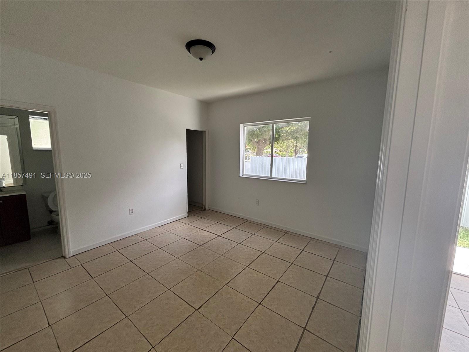 26514 Southwest 138th Avenue, Unit 26514 Homestead, FL 33032 - Photo 13 of 14 an empty room with windows