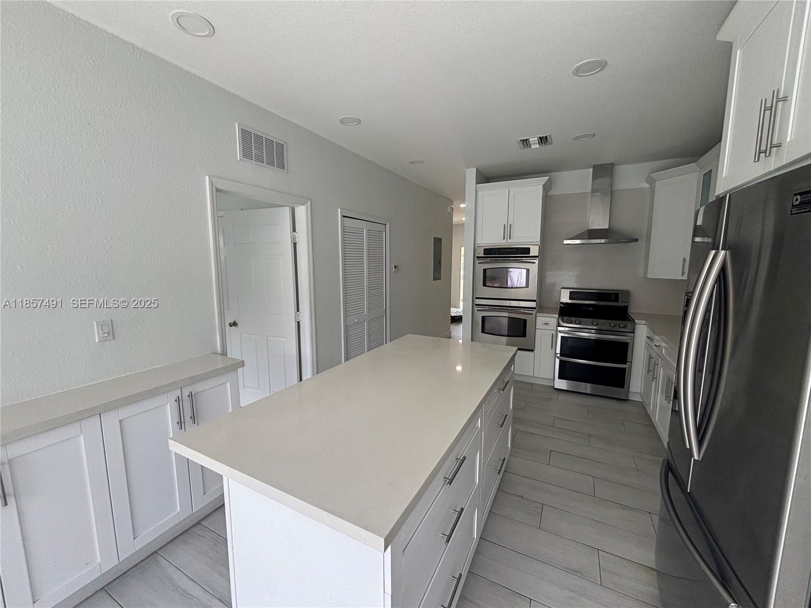 26514 Southwest 138th Avenue, Unit 26514 Homestead, FL 33032 - Photo 5 of 14 a kitchen with stainless steel appliances a refrigerator and a stove top oven
