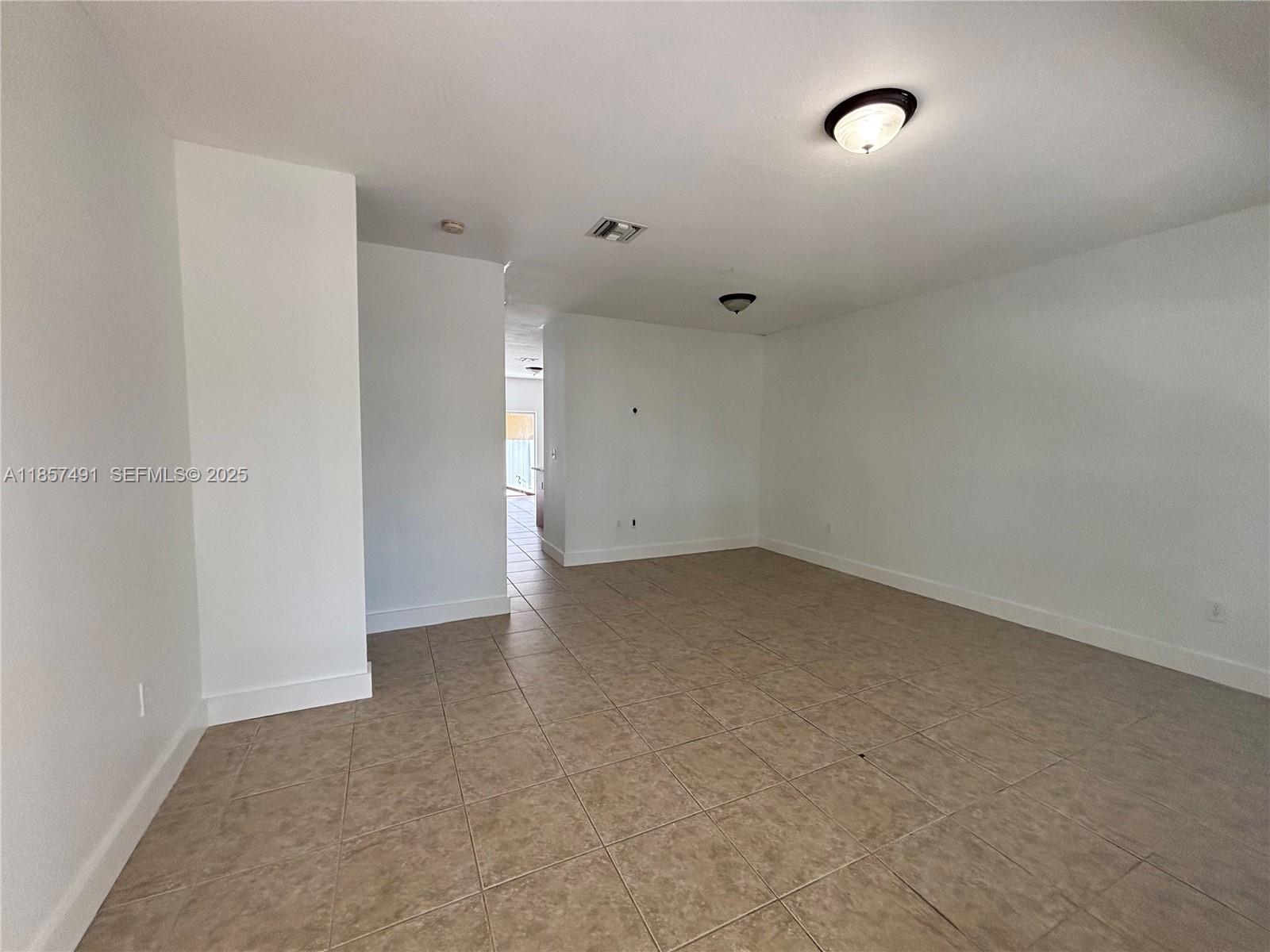 26514 Southwest 138th Avenue, Unit 26514 Homestead, FL 33032 - Photo 10 of 14 an empty room with an entryway