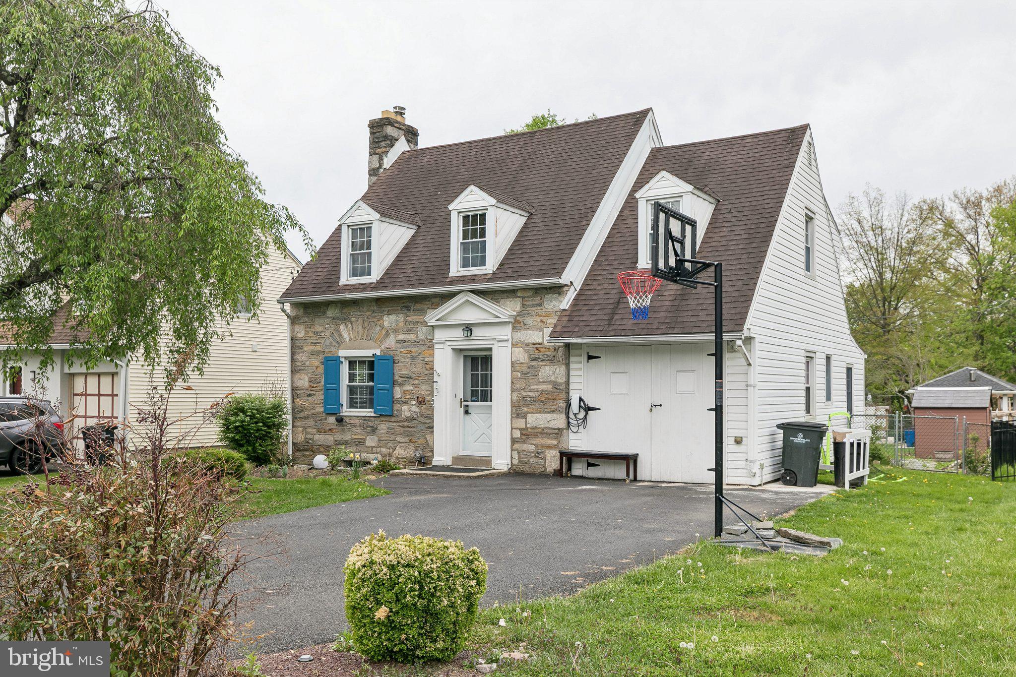 a view of a white house with a sink and yard