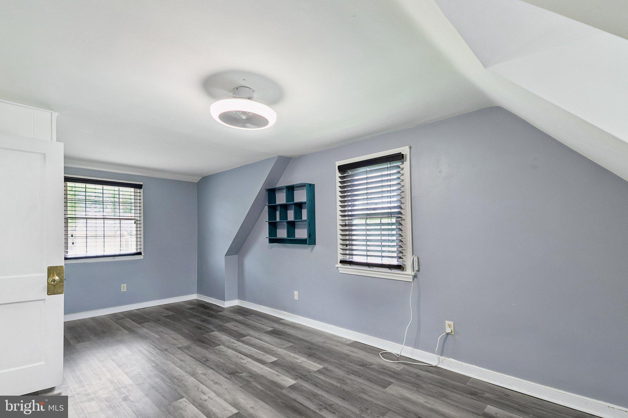 556 Anne Street Huntingdon Valley, PA 19006 - Photo 12 of 50 an empty room with wooden floor and windows
