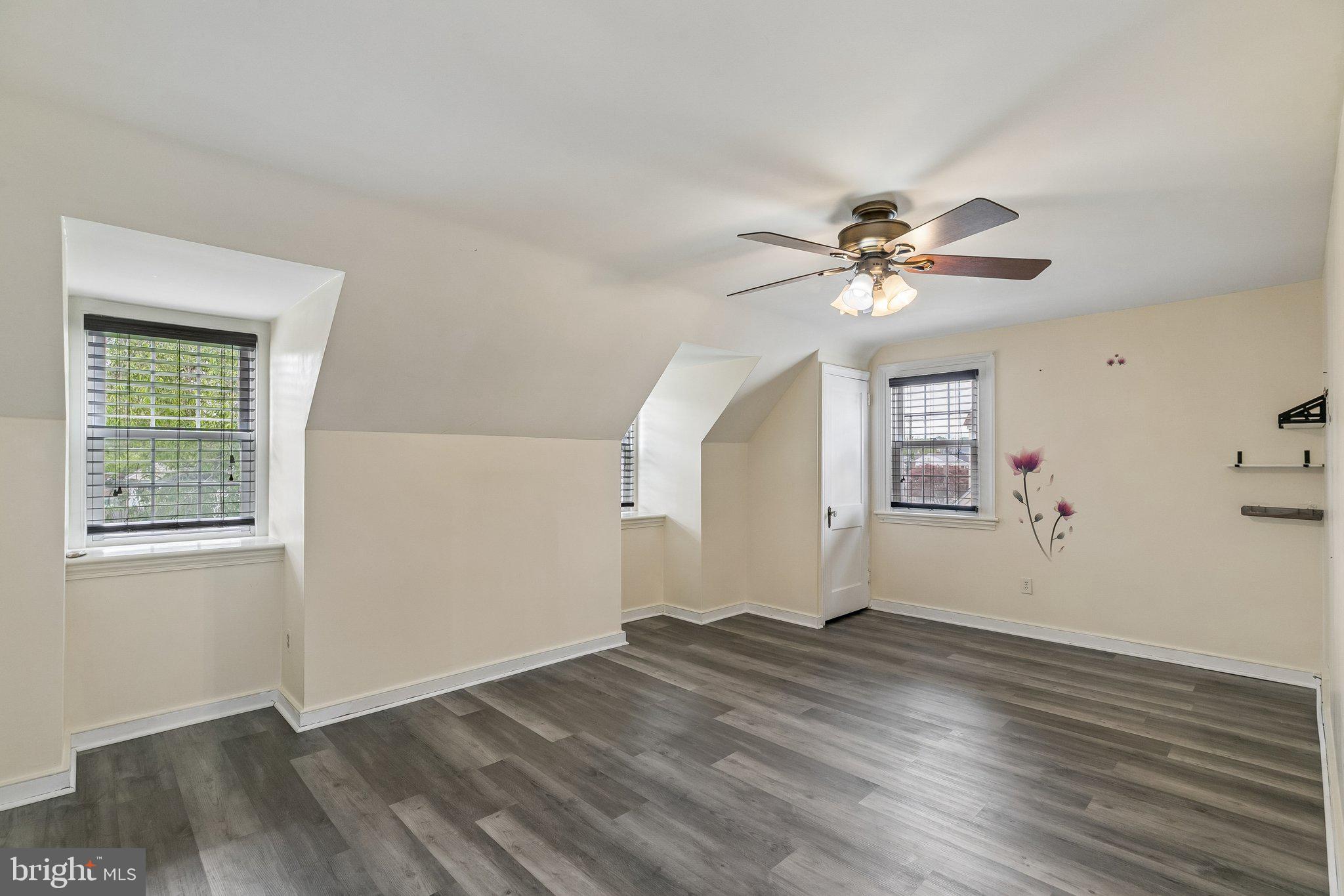 556 Anne Street Huntingdon Valley, PA 19006 - Photo 13 of 50 an empty room with wooden floor chandelier fan and windows