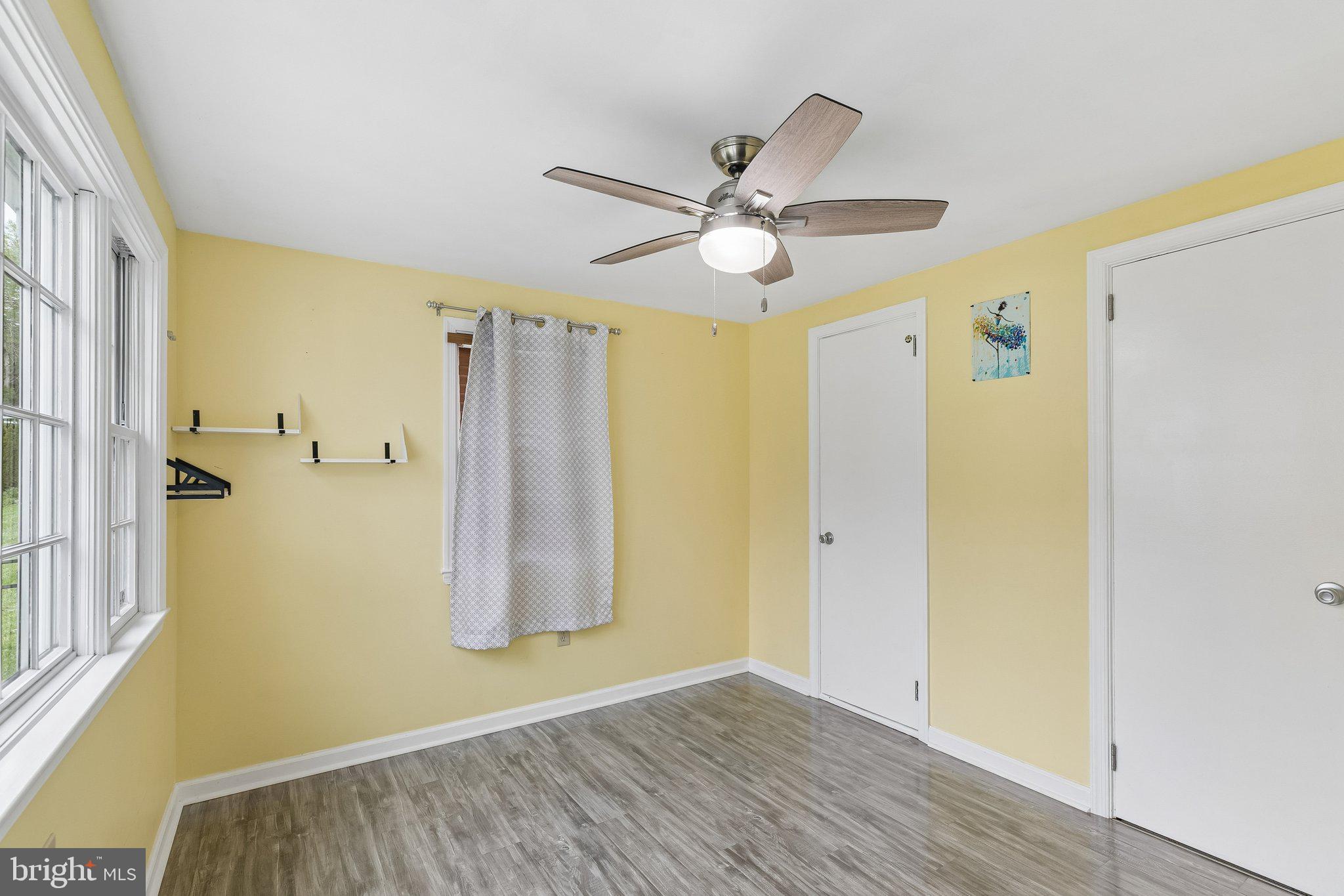 556 Anne Street Huntingdon Valley, PA 19006 - Photo 21 of 50 a view of empty room with wooden floor and fan