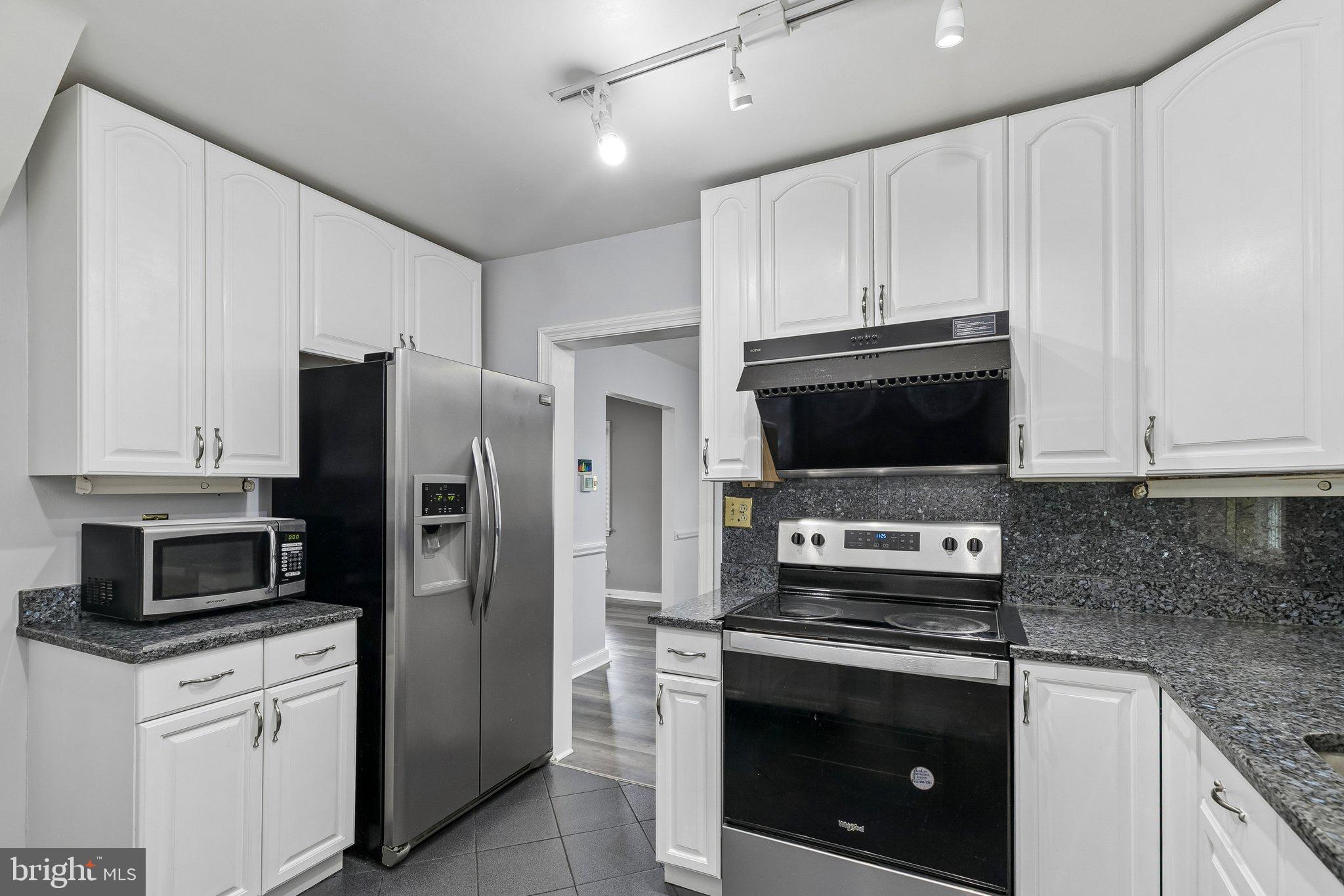 556 Anne Street Huntingdon Valley, PA 19006 - Photo 33 of 50 a kitchen with stainless steel appliances granite countertop a stove a refrigerator and a microwave