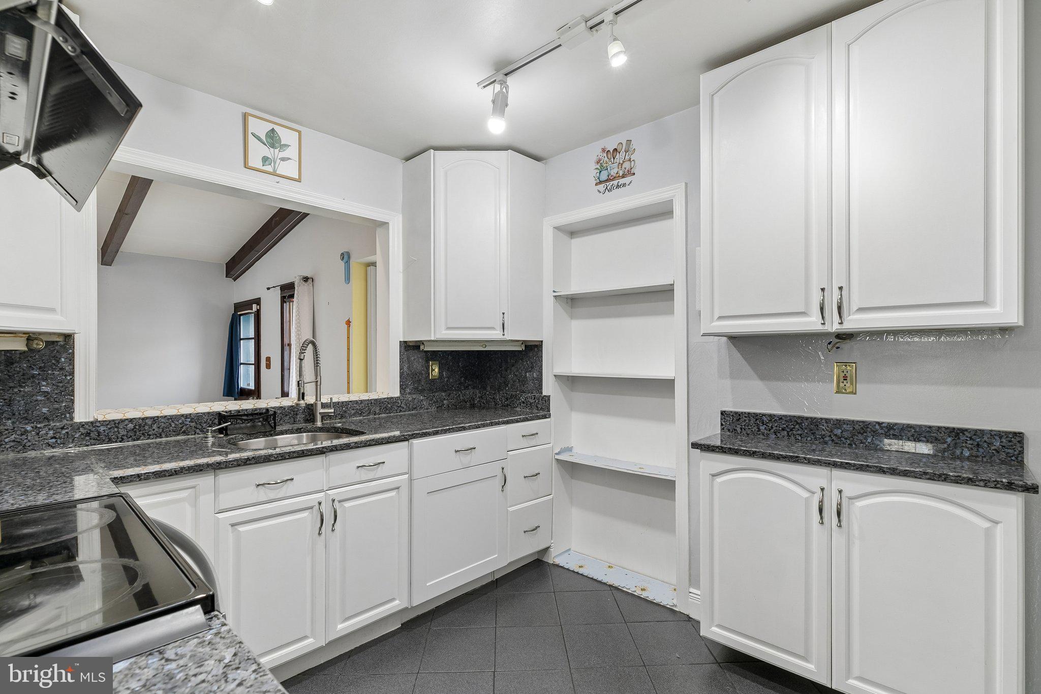 556 Anne Street Huntingdon Valley, PA 19006 - Photo 34 of 50 a kitchen with granite countertop white cabinets and white appliances