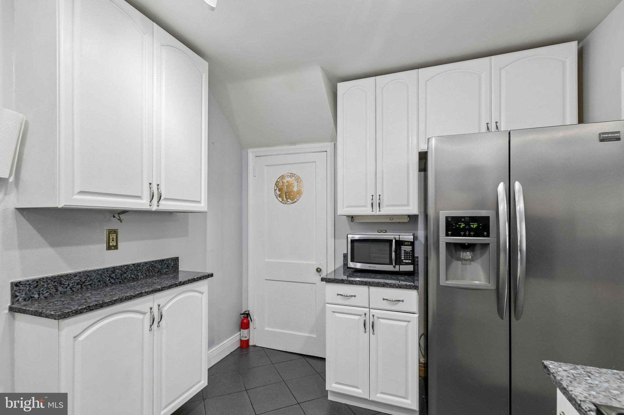 556 Anne Street Huntingdon Valley, PA 19006 - Photo 35 of 50 a kitchen with stainless steel appliances white cabinets and a refrigerator