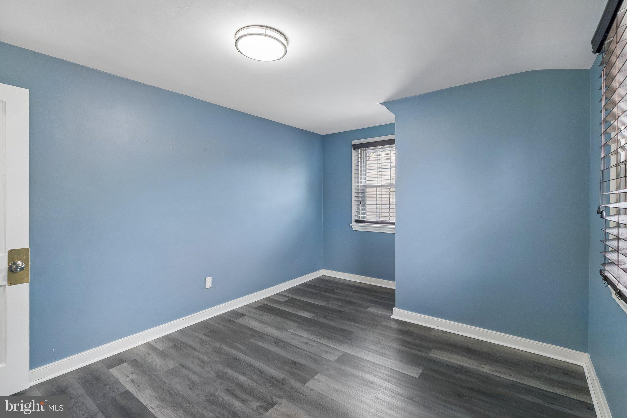 556 Anne Street Huntingdon Valley, PA 19006 - Photo 5 of 50 an empty room with wooden floor and windows
