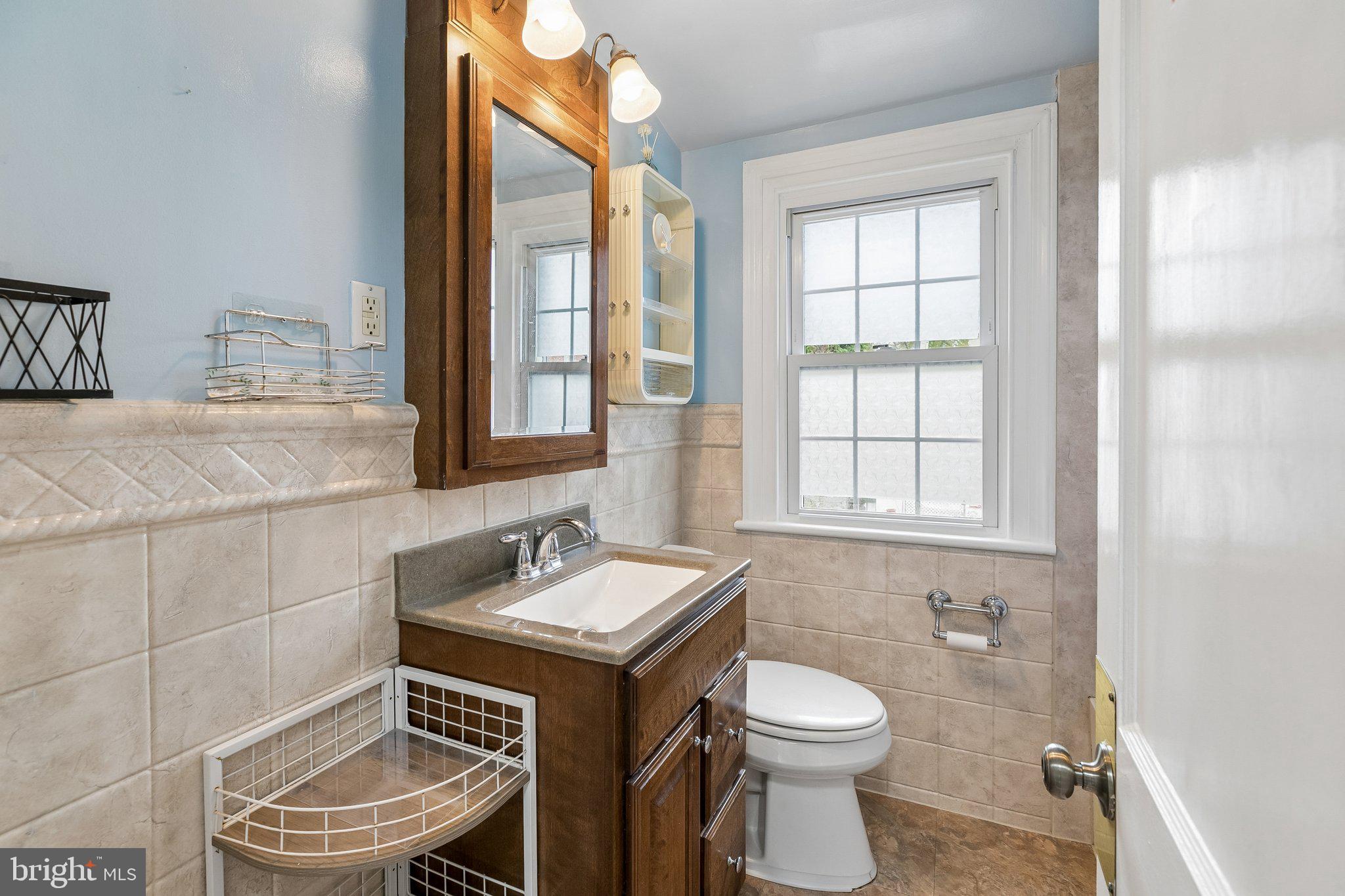 556 Anne Street Huntingdon Valley, PA 19006 - Photo 7 of 50 a bathroom with a toilet sink and mirror