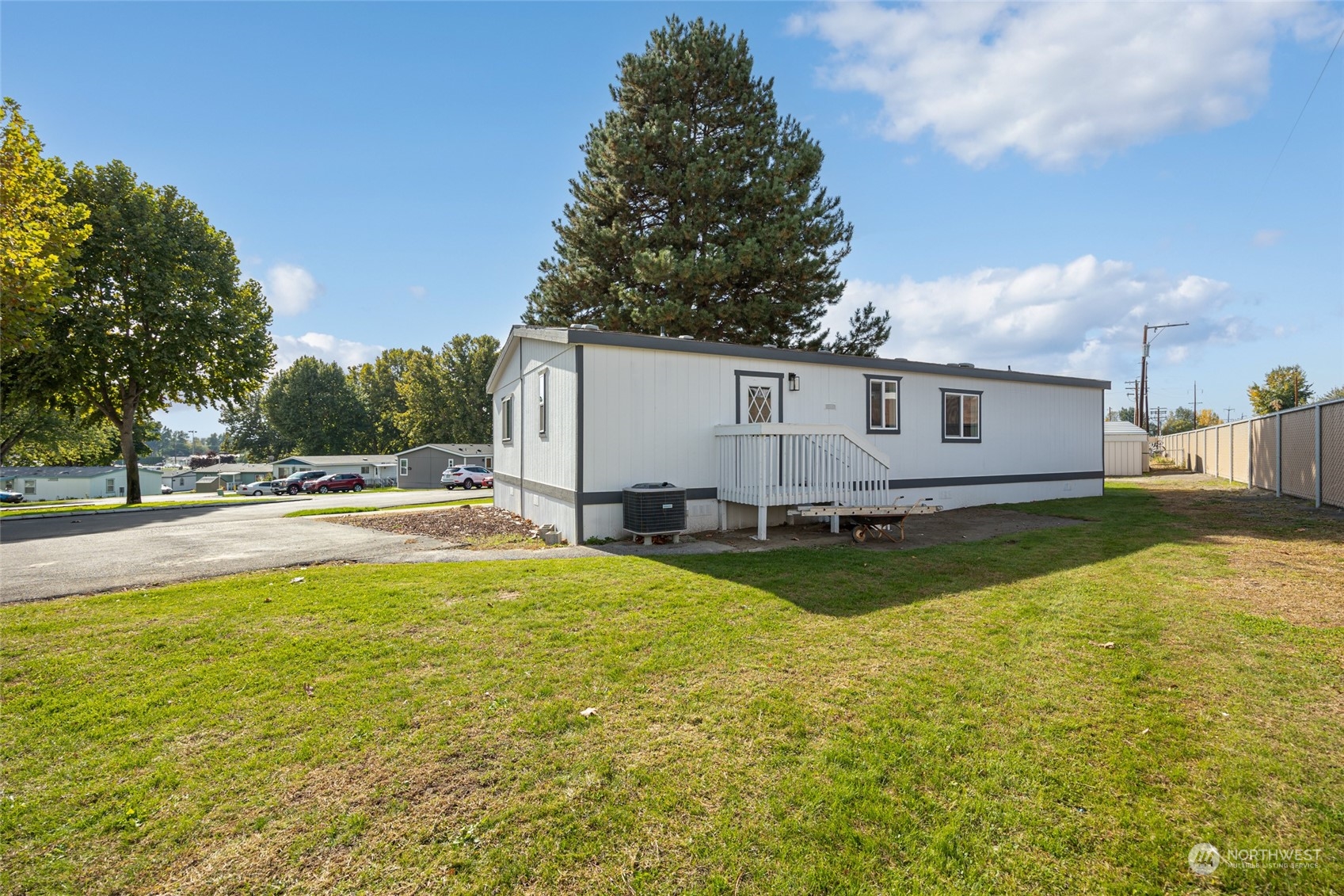 3517 N Road, Unit 115E Pasco, WA 99301 - Photo 24 of 26 a view of pool with lawn chairs and yard
