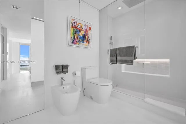 a white toilet sitting next to a bathroom sink