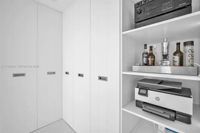 a view of kitchen with refrigerator stove and two windows
