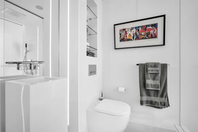 a bathroom with a toilet a sink and a mirror