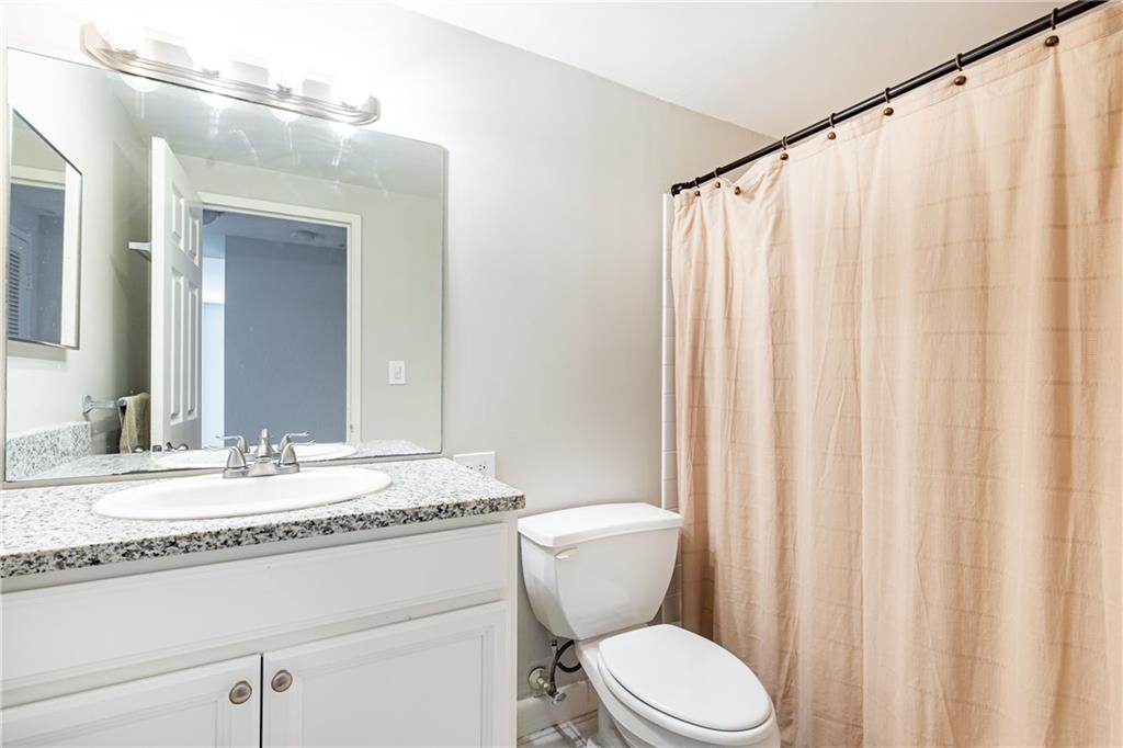 1501 Clairmont Road, Unit 1525 Decatur, GA 30033 - Photo 14 of 26 a bathroom with a granite countertop sink and a mirror