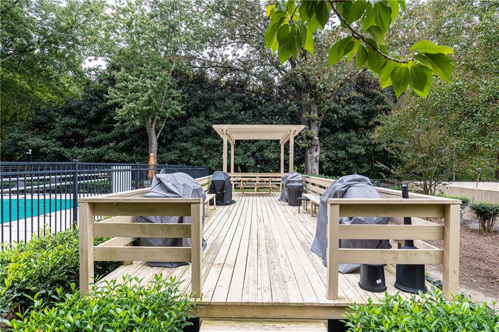 1501 Clairmont Road, Unit 1525 Decatur, GA 30033 - Photo 22 of 26 a view of a patio with table and chairs potted plants and large tree
