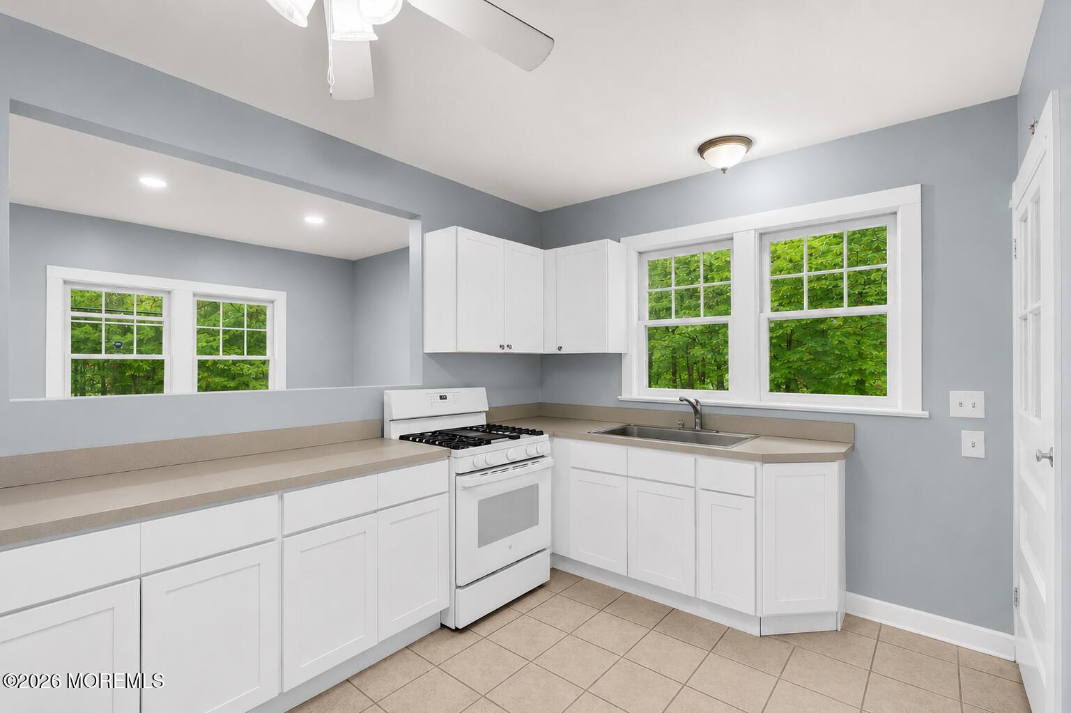 269 Alexander Avenue Howell, NJ 07731 - Photo 11 of 43 a kitchen with a sink window and cabinets