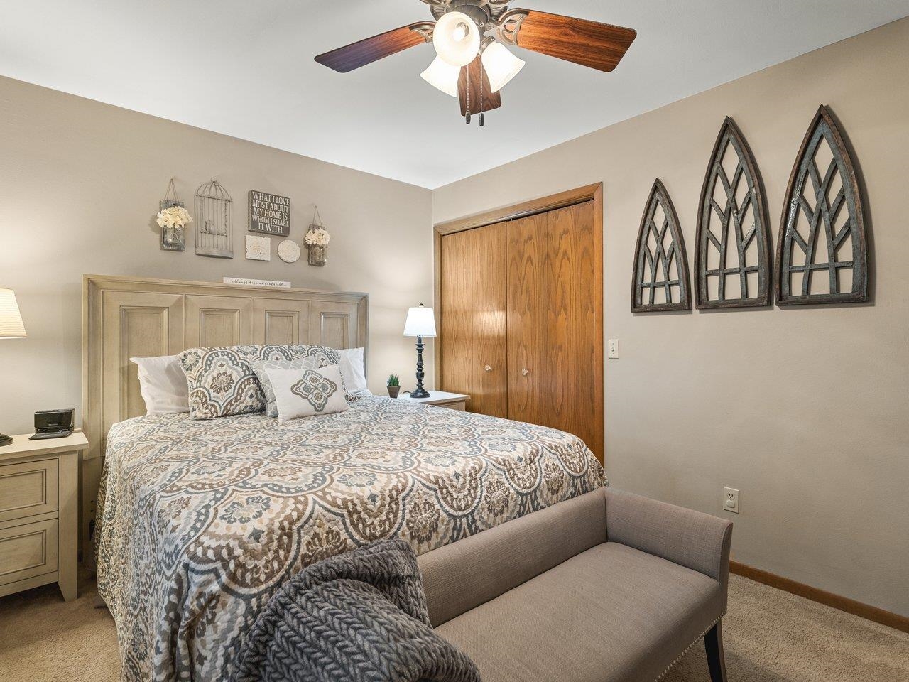 1816 Post Road Beloit, WI 53511 - Photo 19 of 42 a bedroom with a bed and a chandelier
