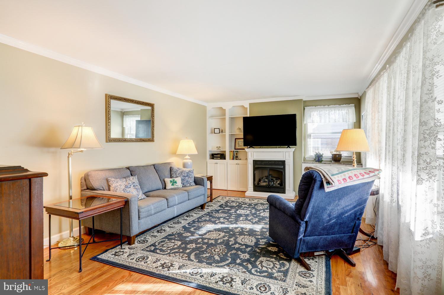 341 Maxson Road Lancaster, PA 17601 - Photo 4 of 32 a living room with furniture a flat screen tv and a fireplace