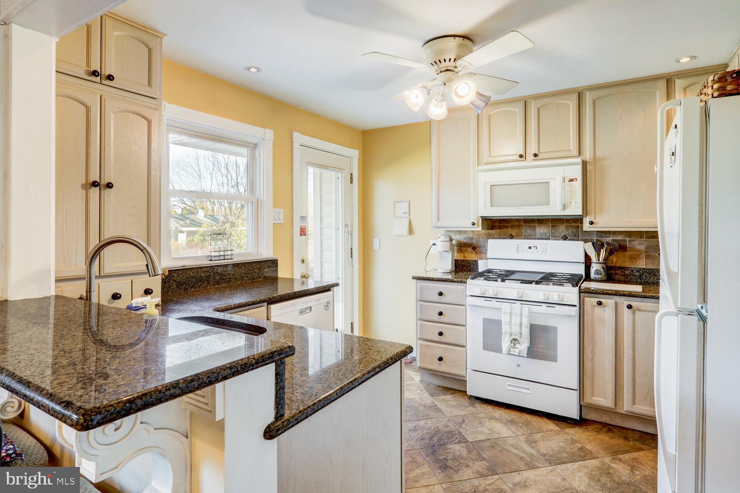 341 Maxson Road Lancaster, PA 17601 - Photo 8 of 32 a kitchen with stainless steel appliances granite countertop a stove refrigerator and cabinets