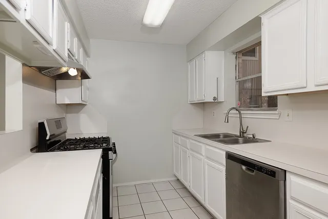 a kitchen with a sink and cabinets