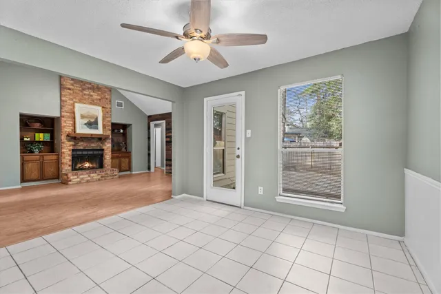 a view of a livingroom with a furniture chandelier fan and a fireplace