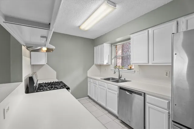a kitchen with a sink appliances and cabinets