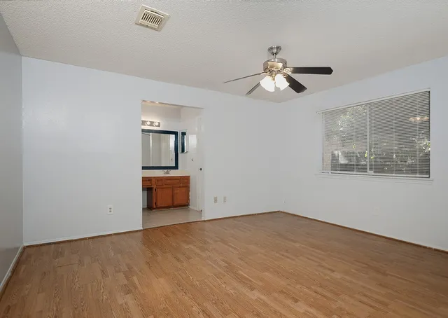 a view of empty room with wooden floor