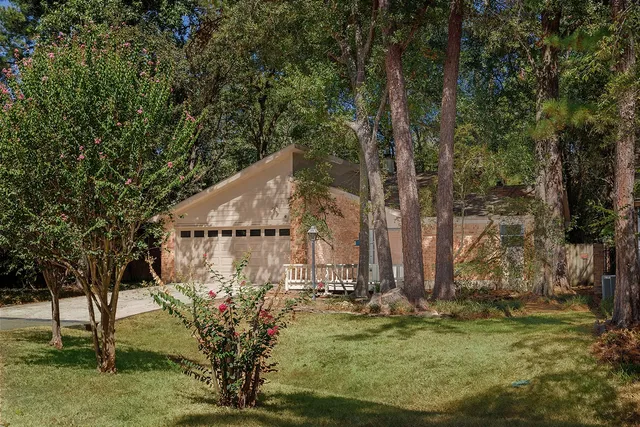 a view of a house with large trees