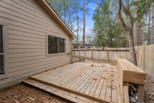 a view of a backyard with a barbeque and wooden stairs