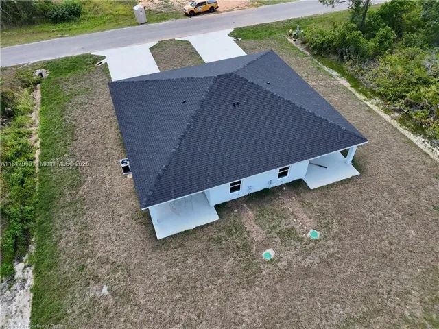 an aerial view of a house with a yard