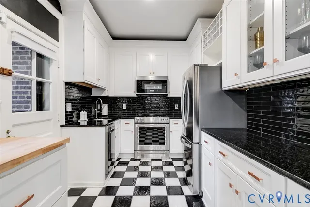 a kitchen with granite countertop a stove and a sink